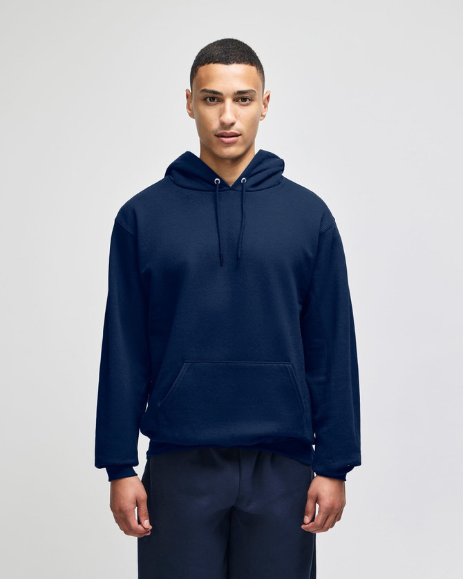 A navy blue pullover hooded sweatshirt with a front pocket and a logo. The model is wearing it against a plain background.