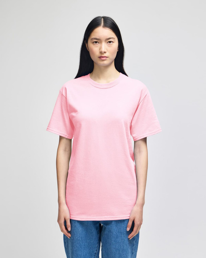 A pink short-sleeve t-shirt displayed on a model, featuring a basic design and a logo on the front.