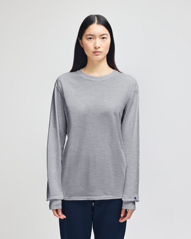 A long-sleeve grey t-shirt with a relaxed fit, featuring a logo on the sleeve.