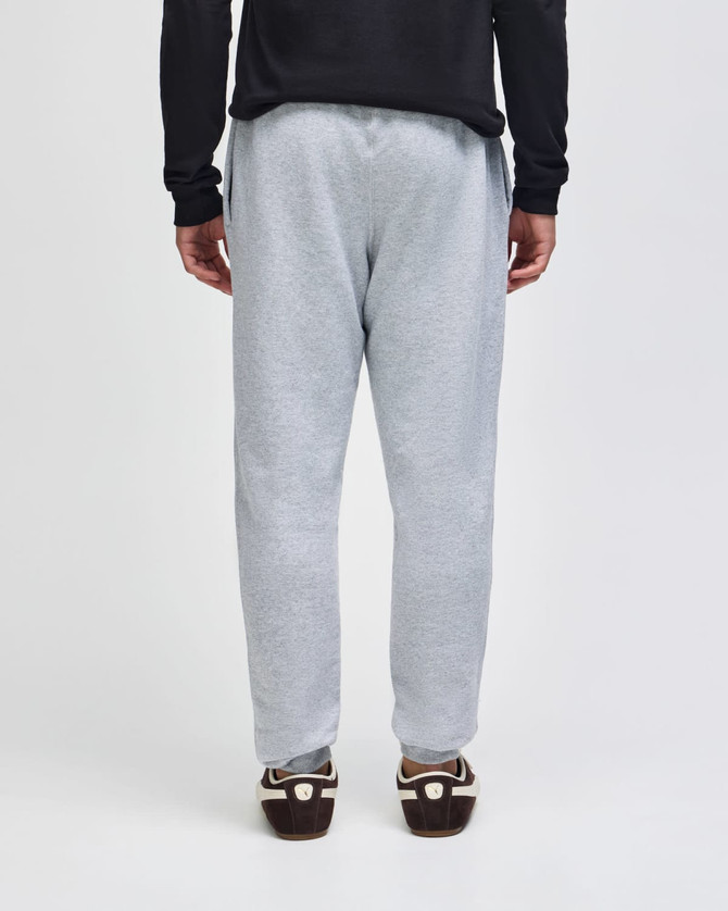A pair of grey fleece joggers with an elastic waistband, featuring a casual fit and a logo.