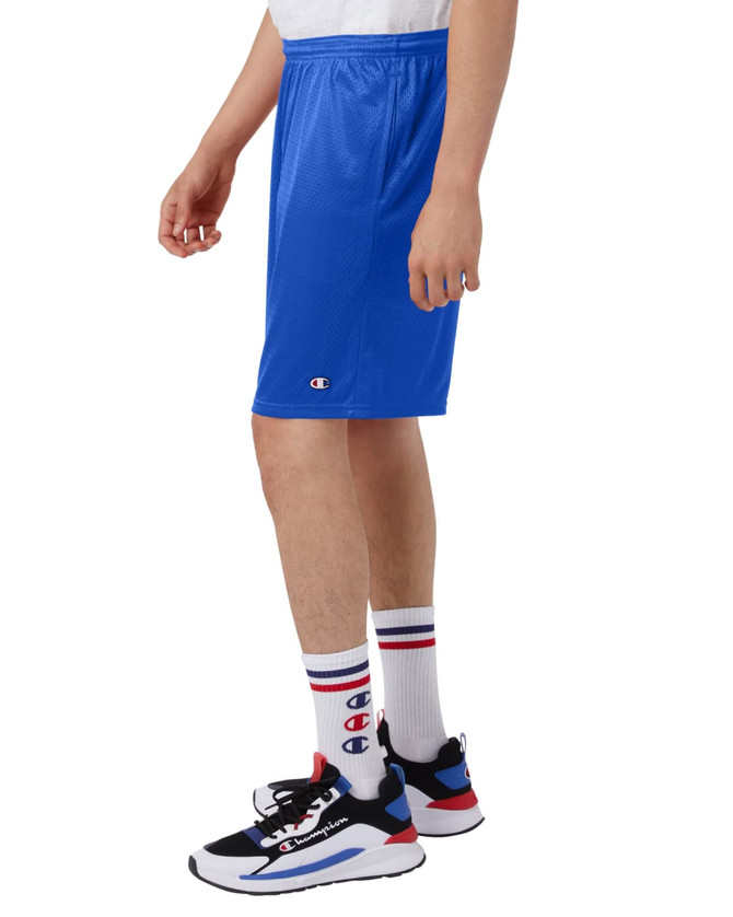 Blue sports shorts with pockets, featuring a logo, worn with socks and sneakers.