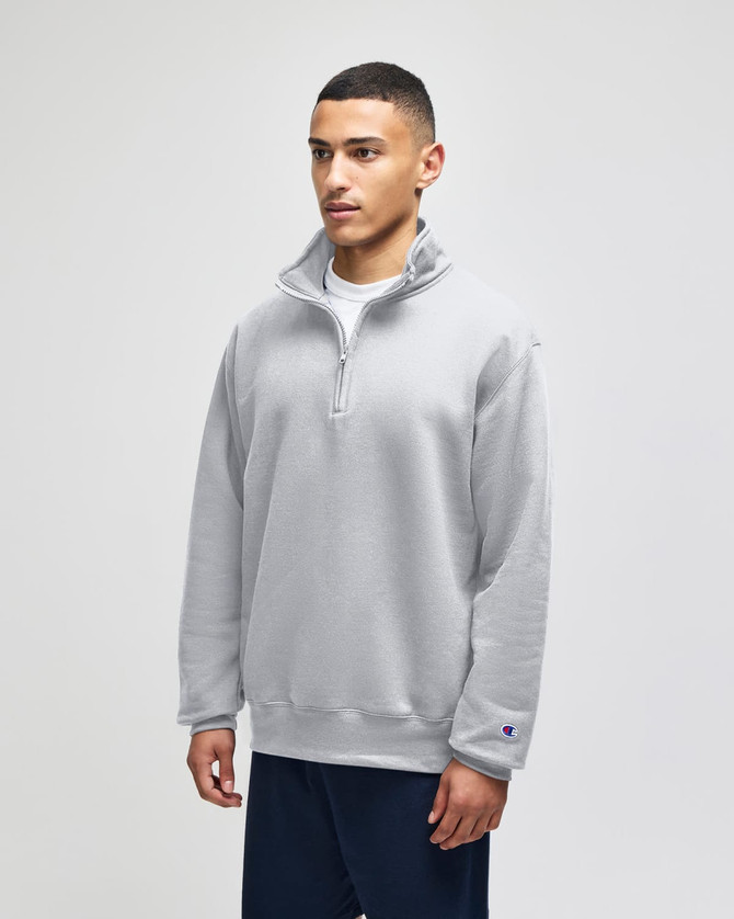 A grey quarter-zip pullover jacket designed for adults, featuring long sleeves and a logo on the sleeve.