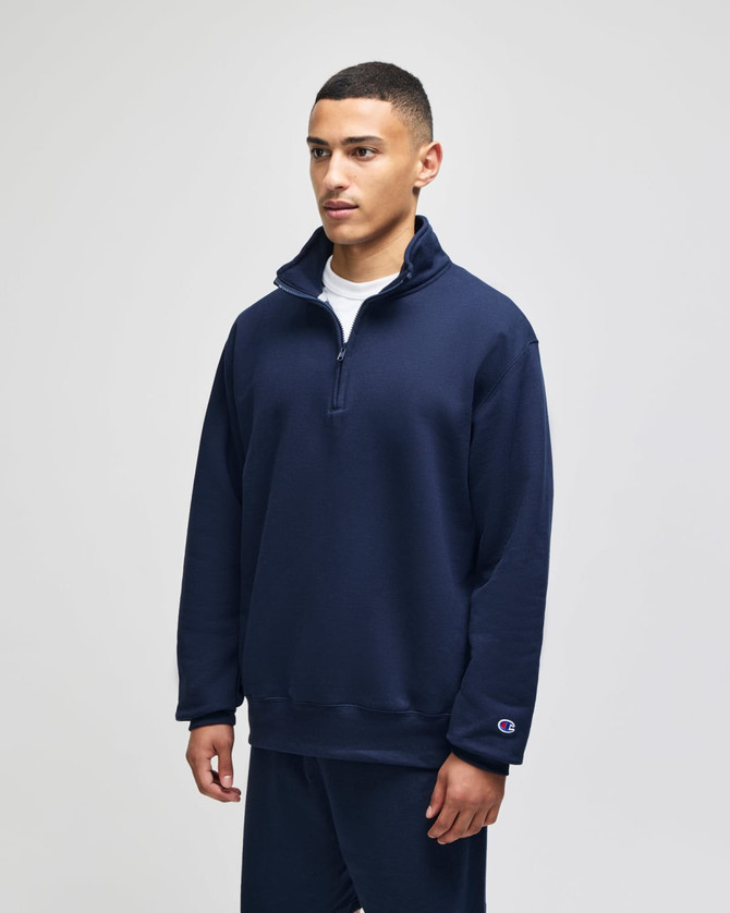 A navy blue quarter-zip pullover featuring a stand-up collar and a small logo on the sleeve.