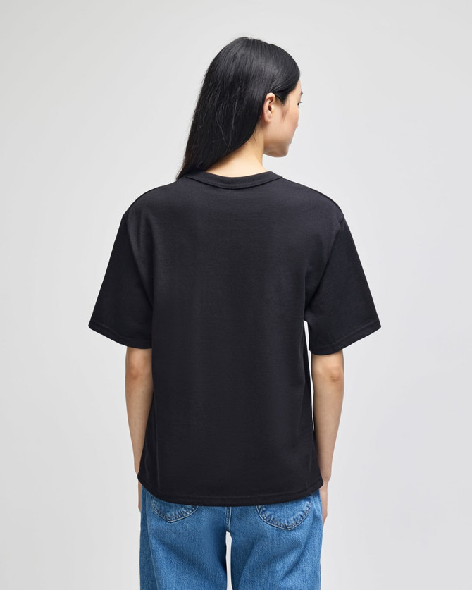 A black Champion Adult Heritage Jersey T-Shirt featuring a relaxed fit and short sleeves.