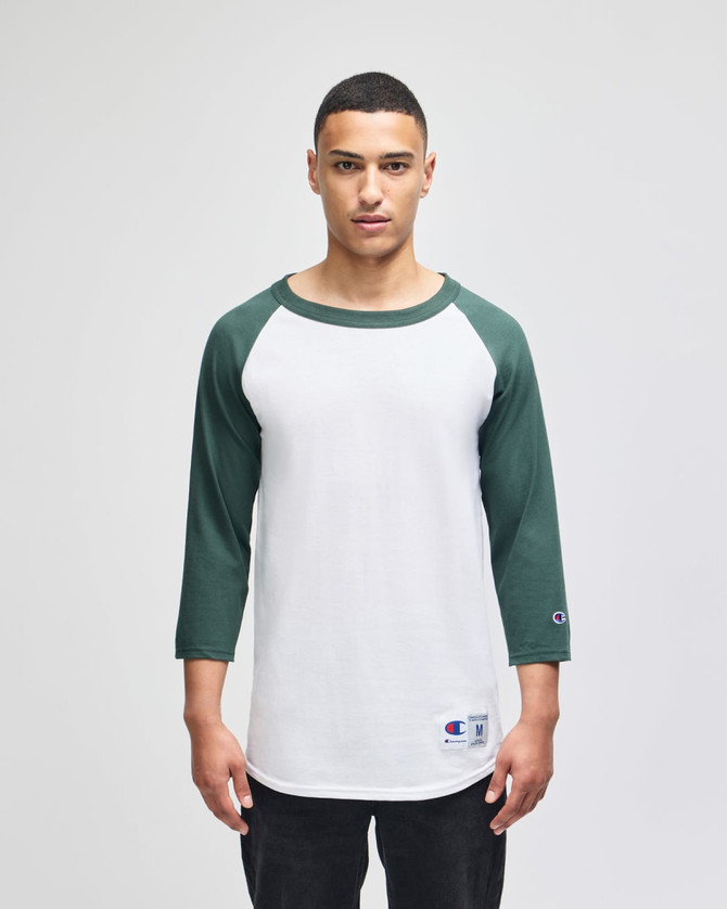A men's raglan baseball T-shirt with white body and green sleeves, featuring a logo on the hem.