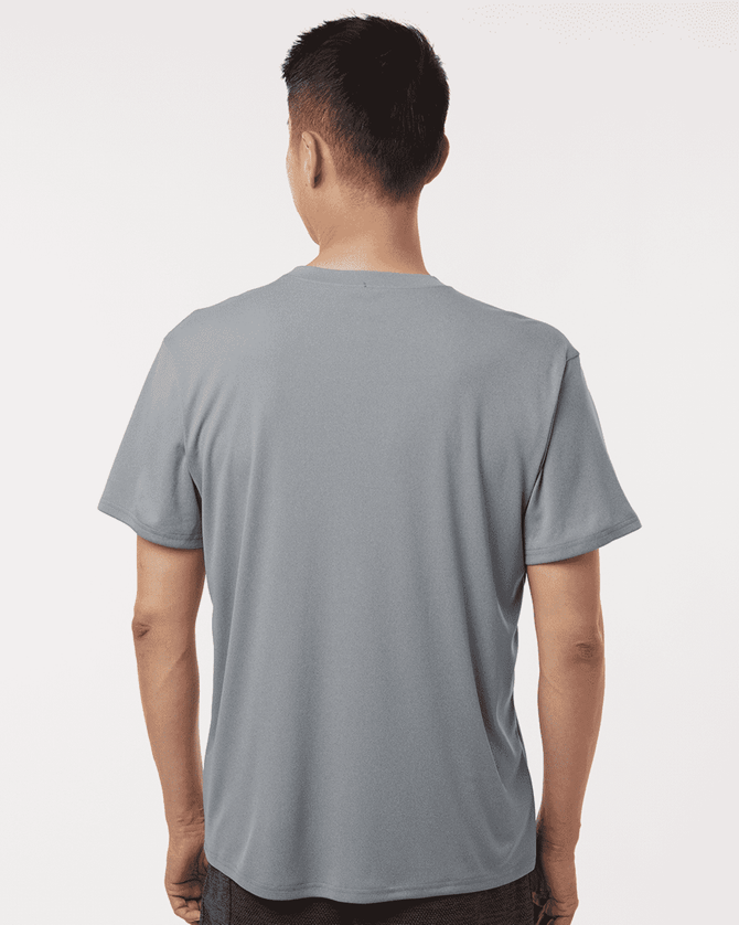 A grey men's performance t-shirt is displayed, featuring a simple design with a logo on the back.