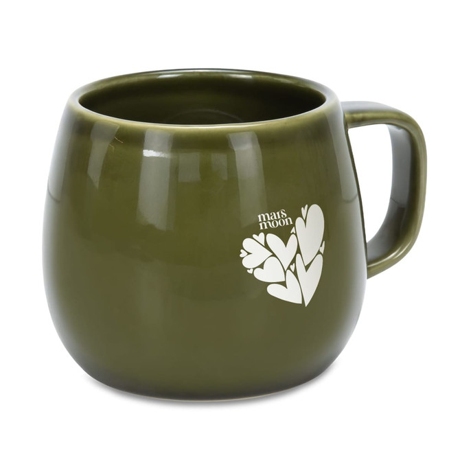 A green ceramic coffee mug with a rounded shape and a handle, featuring a simple heart design and a logo.