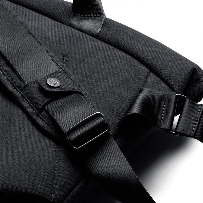 A black messenger bag featuring adjustable straps and a logo. The material appears textured and durable.