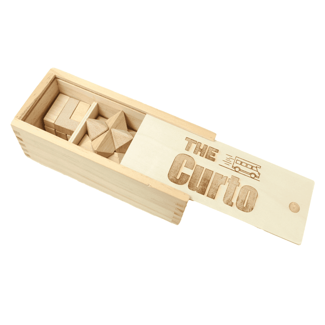 A wooden puzzle set featuring various geometric shapes in a light wood box with a hinged lid and engraved design.