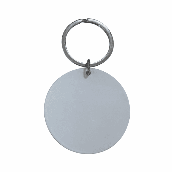 A keyring featuring a large, circular blank tag in silver metal.