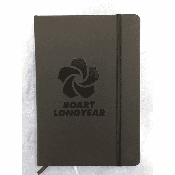 A dark grey notebook with a logo on the cover and an elastic band closure.