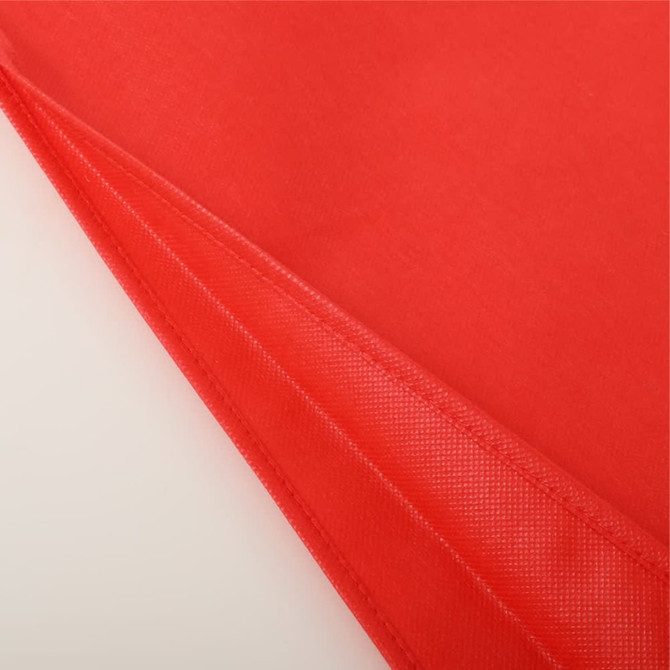 A red non-woven tote bag with a smooth texture and a stitched seam, featuring an interior lining.