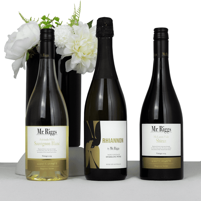 A drink bottle set featuring three wine bottles: Sauvignon Blanc, sparkling wine, and Shiraz, with a floral vase in the background.