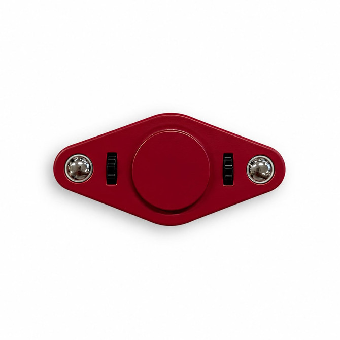 A red fidget spinner with two switches and a central button, featuring shiny silver ends and a smooth surface.