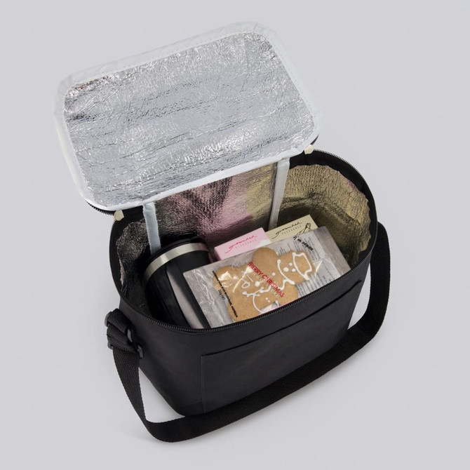 A black cooler bag with a silver interior, containing wrapped gifts and a drink bottle.