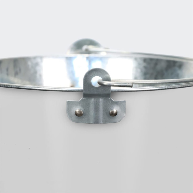 A metallic ice bucket with a handle, featuring a shiny, smooth surface and a rustic aesthetic.