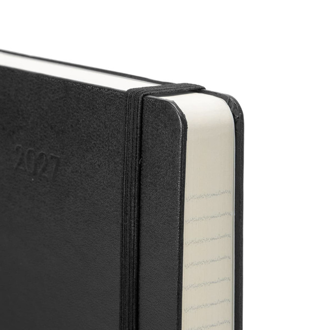 A black 2027 Moleskine planner with a textured cover and elastic band closure, featuring white pages with lined edges.