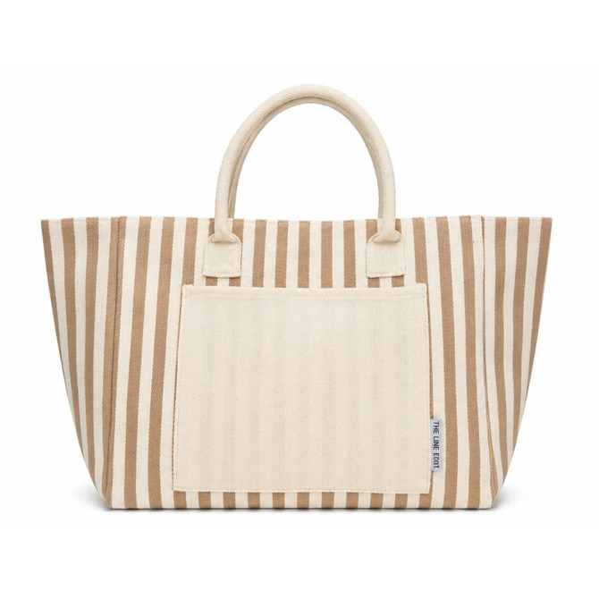 A striped tote bag in beige and cream featuring two handles and a front pocket. Branding is present on the bag.
