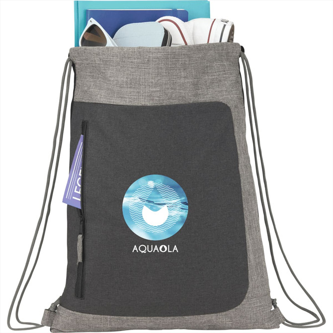 A grey drawstring bag with a front pocket, featuring a logo, and various items peeking out from the top.