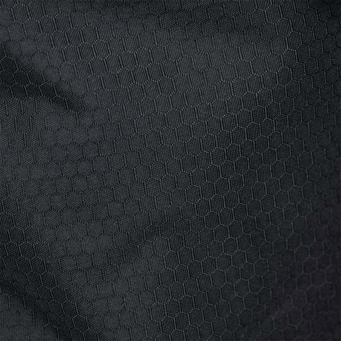 A close-up of textured, black fabric featuring a hexagonal pattern, suitable for duffel bags.