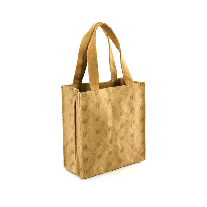 A kraft paper tote bag in a light brown shade with sturdy handles and a logo on the front.