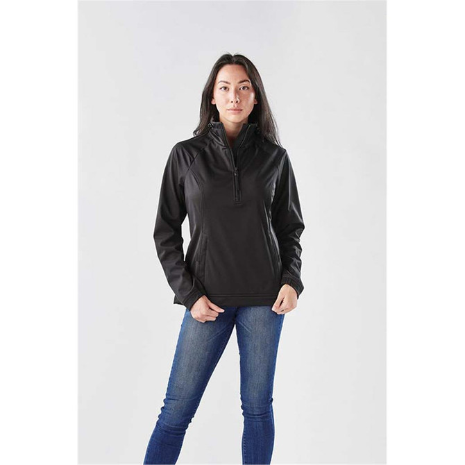 A woman wearing a black Catskill Anorak jacket, paired with blue jeans, poses against a plain background.