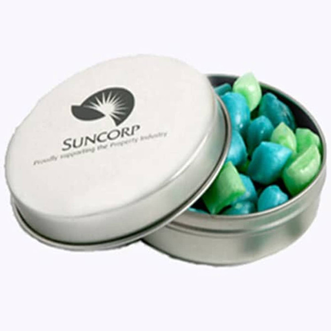 A silver tin containing tiny green and blue humbugs. The tin features a logo.