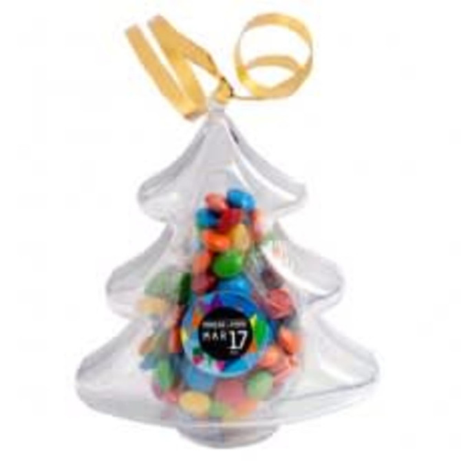Acrylic Christmas tree filled with colourful M&Ms, featuring a decorative gold ribbon and a branded sticker.