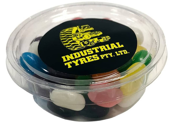 A tub filled with colourful jelly beans in various flavours, featuring a black lid with a logo.