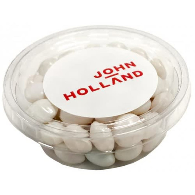 A clear tub filled with white mints, featuring a label with a logo.