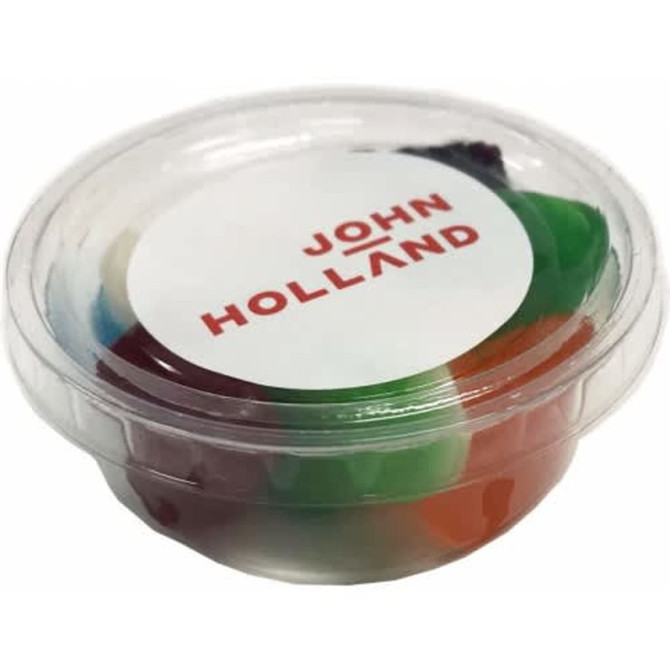 A tub filled with mixed lollies in various colours, enclosed in a clear plastic container with a logo.