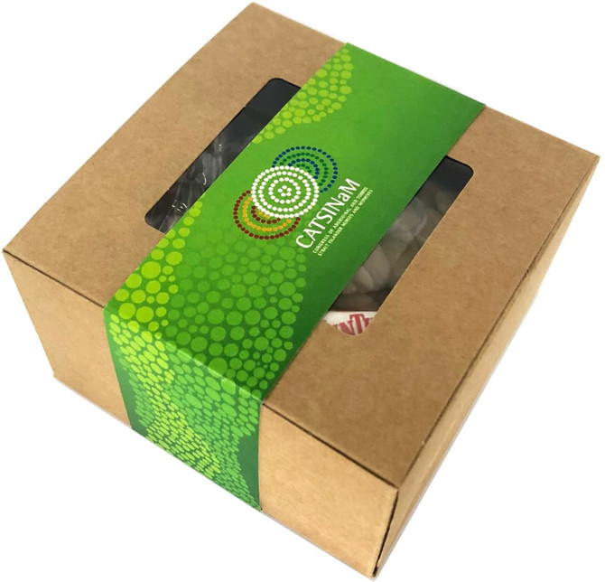 A small kraft gift box with a green sleeve, featuring a clear window displaying its contents.