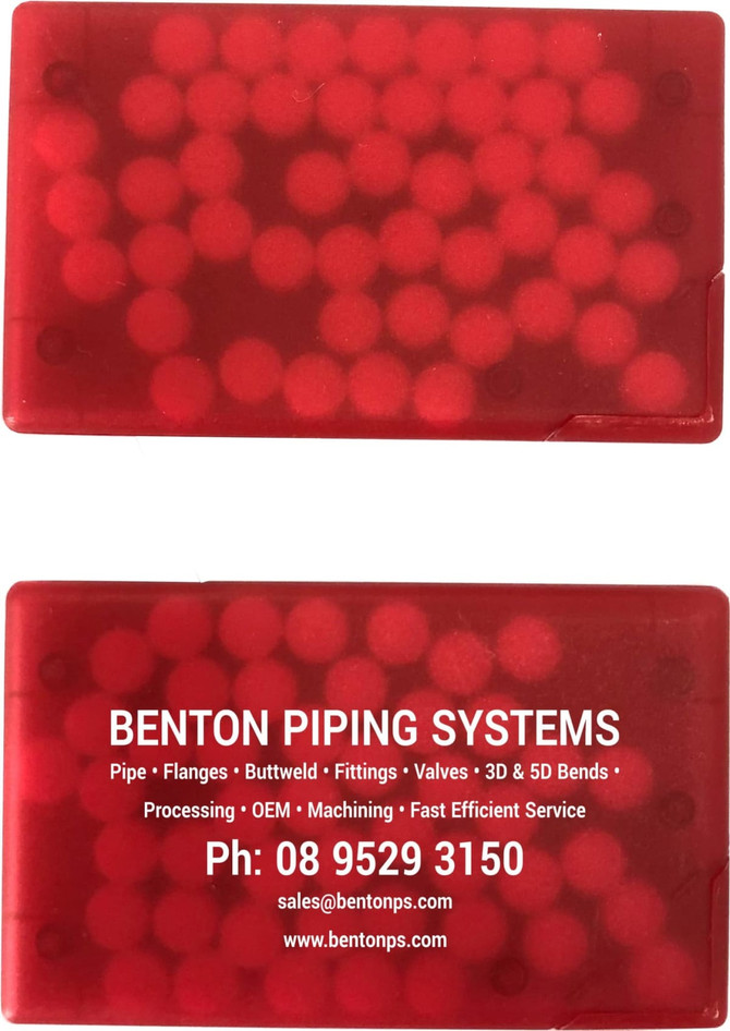 A red credit card-sized mint container filled with round mints, featuring a logo and contact information.