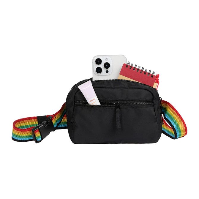 A black fanny pack features a rainbow strap, holding a phone, a notebook, and a small tube.