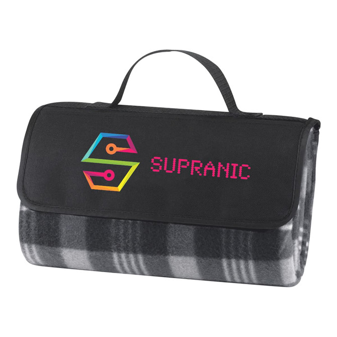 A folded picnic rug in grey and black checkered pattern with a black carrying strap and a logo on the front.