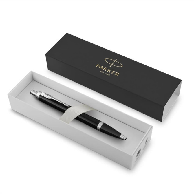 A matte black ballpoint pen in an elegant white box, featuring a silver accent and a ribbon.
