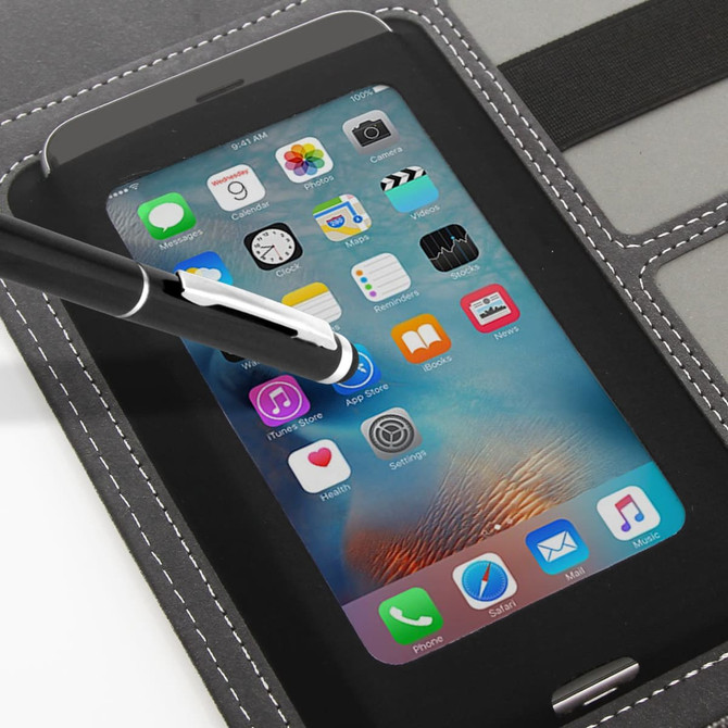 A smartphone with a stylus placed on a black tech organiser featuring grey stitching and multiple slots.