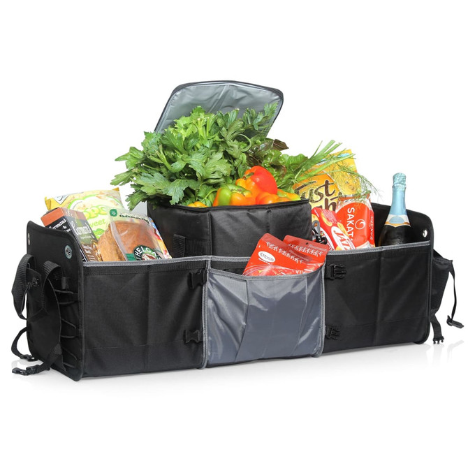 A black car boot organiser filled with groceries, including vegetables, snacks, and a drink bottle, featuring a cooler compartment.
