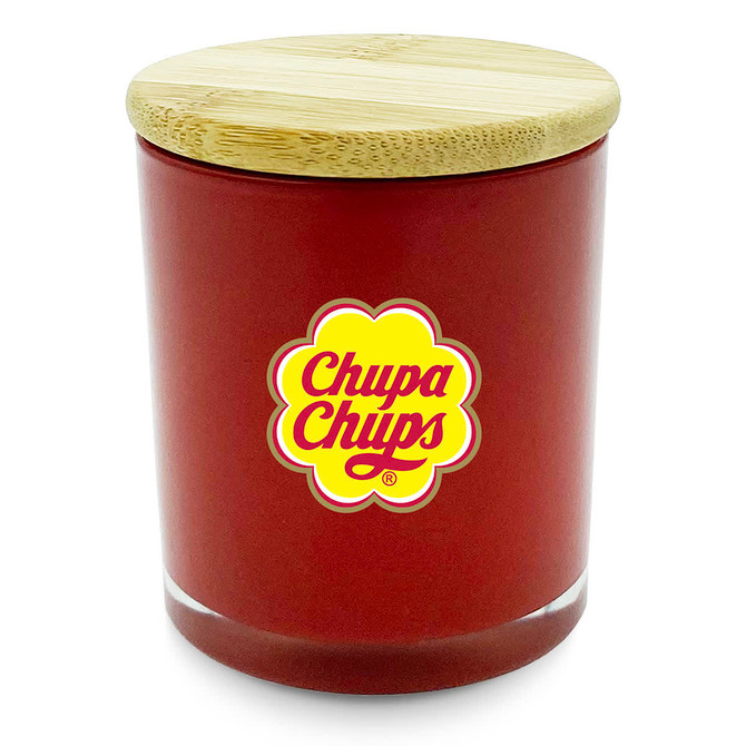 A large red candle with a wooden lid and a logo on the front.
