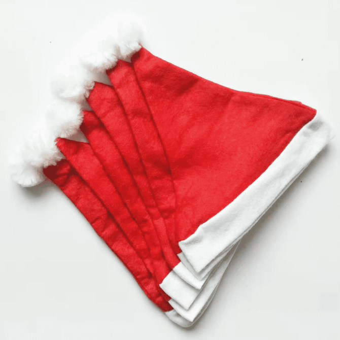 A set of red Christmas Santa hats with white fluffy trim, arranged in a stack.
