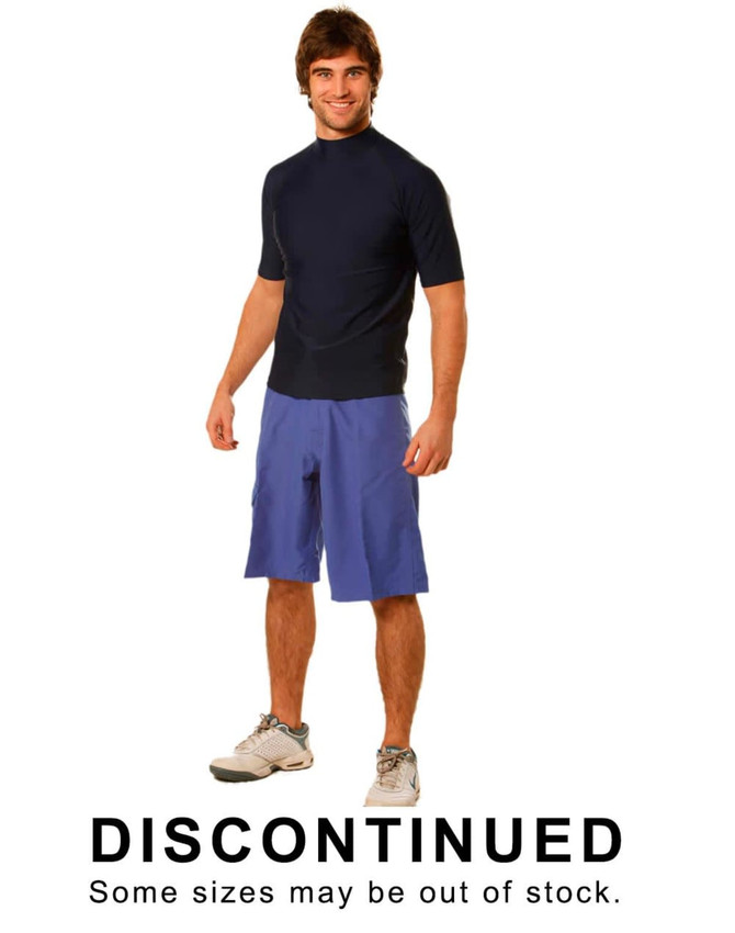 A man wearing navy surf shorts made of 100% polyester, styled with a short-sleeve top. The shorts are a light blue shade.