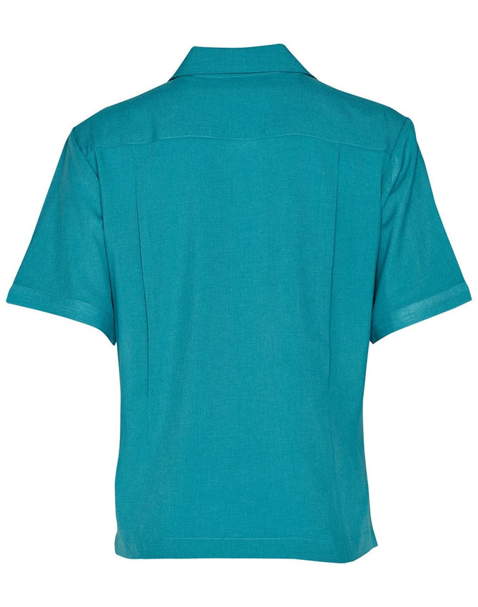 A teal short sleeve overblouse with a collared neck and back pleats, featuring a logo.