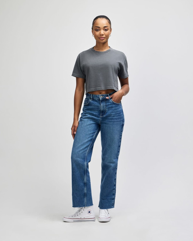 A grey heavy cotton crop boxy T-shirt worn with blue jeans, featuring a relaxed fit and short sleeves.