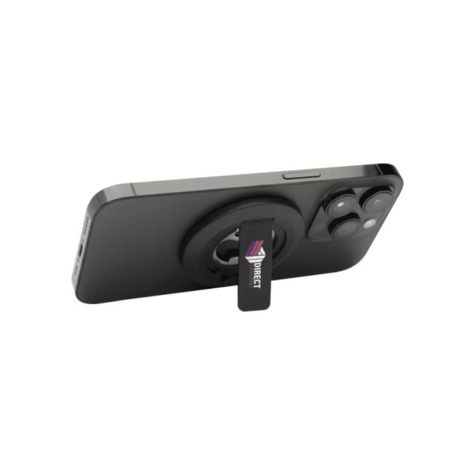A magnetic phone stand in black, featuring a bottle opener and a logo, mounted on the back of a smartphone.