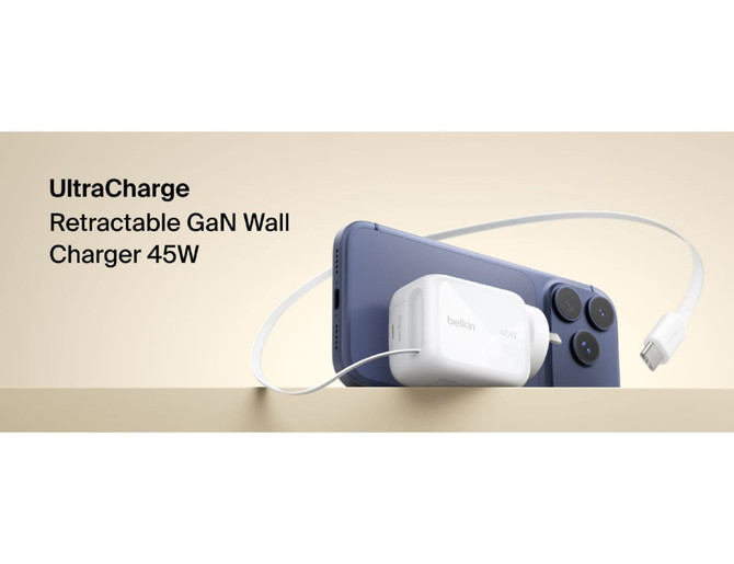 A white 45W retractable GaN wall charger rests against a smartphone, featuring a charging cable connected to it.