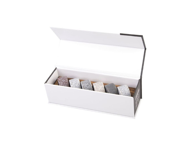 Whisky disc set featuring six granite stones in various colours, presented in a white box with a wooden base.