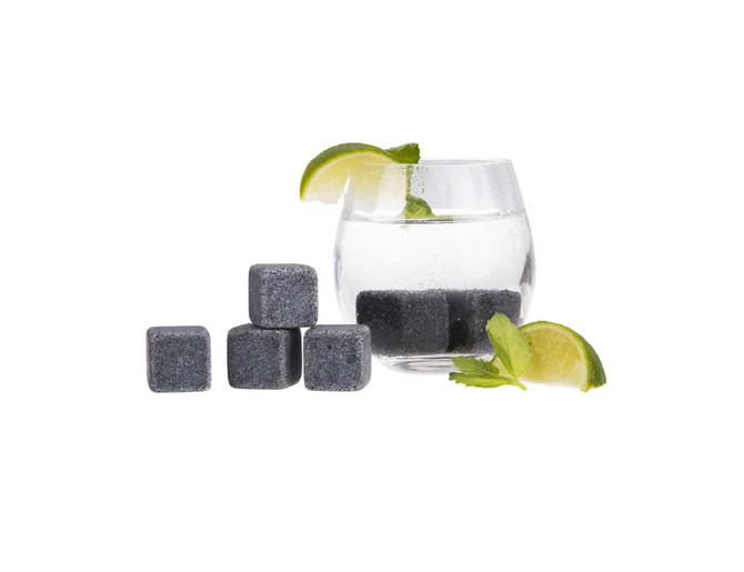 A glass with water and lime slices, surrounded by grey drink chillers and fresh mint leaves.