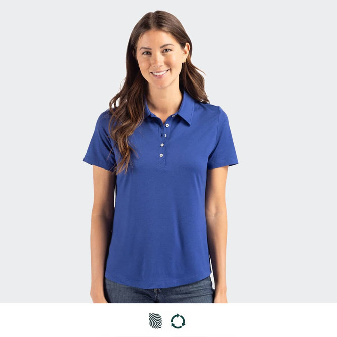 A woman wearing a blue polo shirt with a collar and buttons, standing against a neutral background.