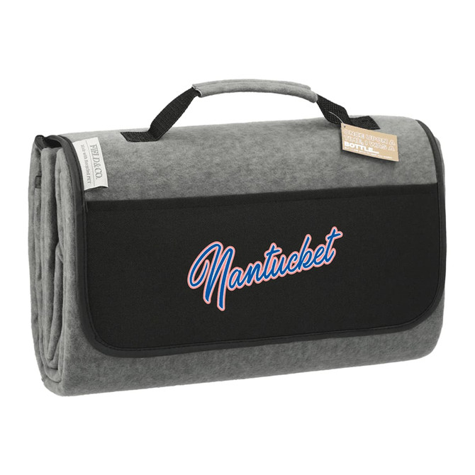 An oversized picnic rug in grey with a black carrying strap and a logo.