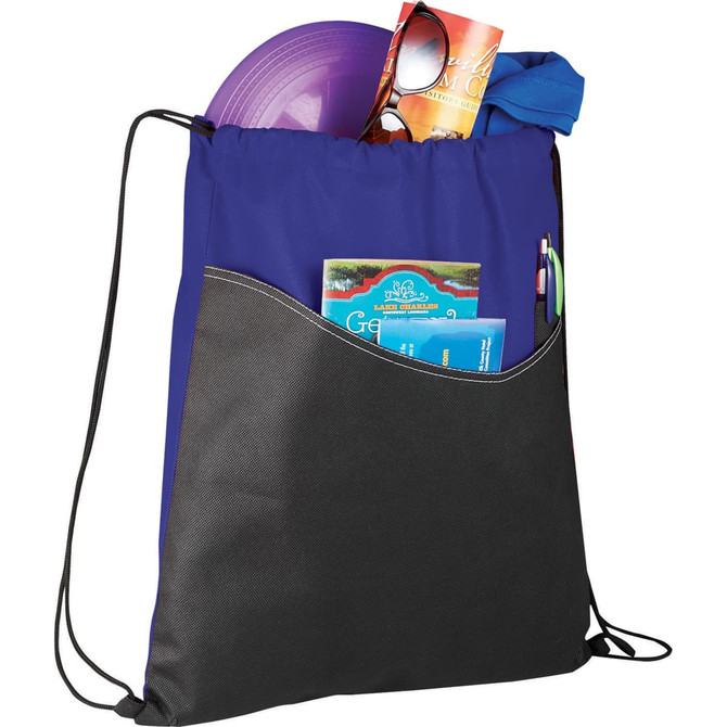 A purple and black non-woven drawstring sportspack filled with a frisbee, sunglasses, and various items.